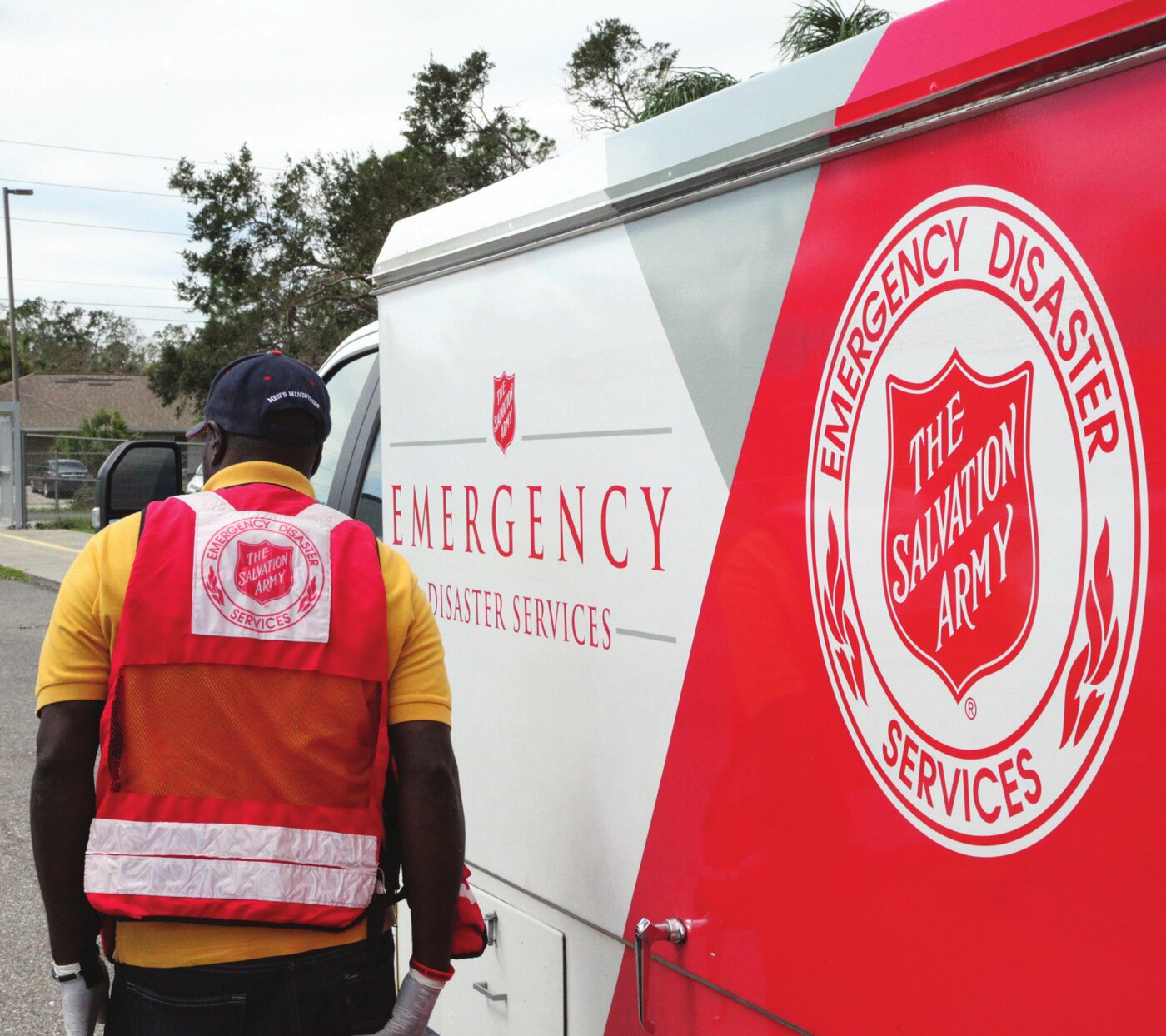 A Salvation Army Emergency Disaster Services worker beside a response vehicle